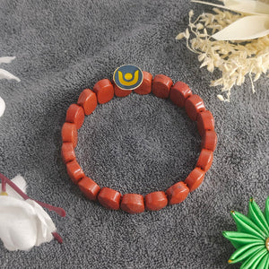 Red Jasper Oval Faceted Bracelet — clasp and elastic threading detail
