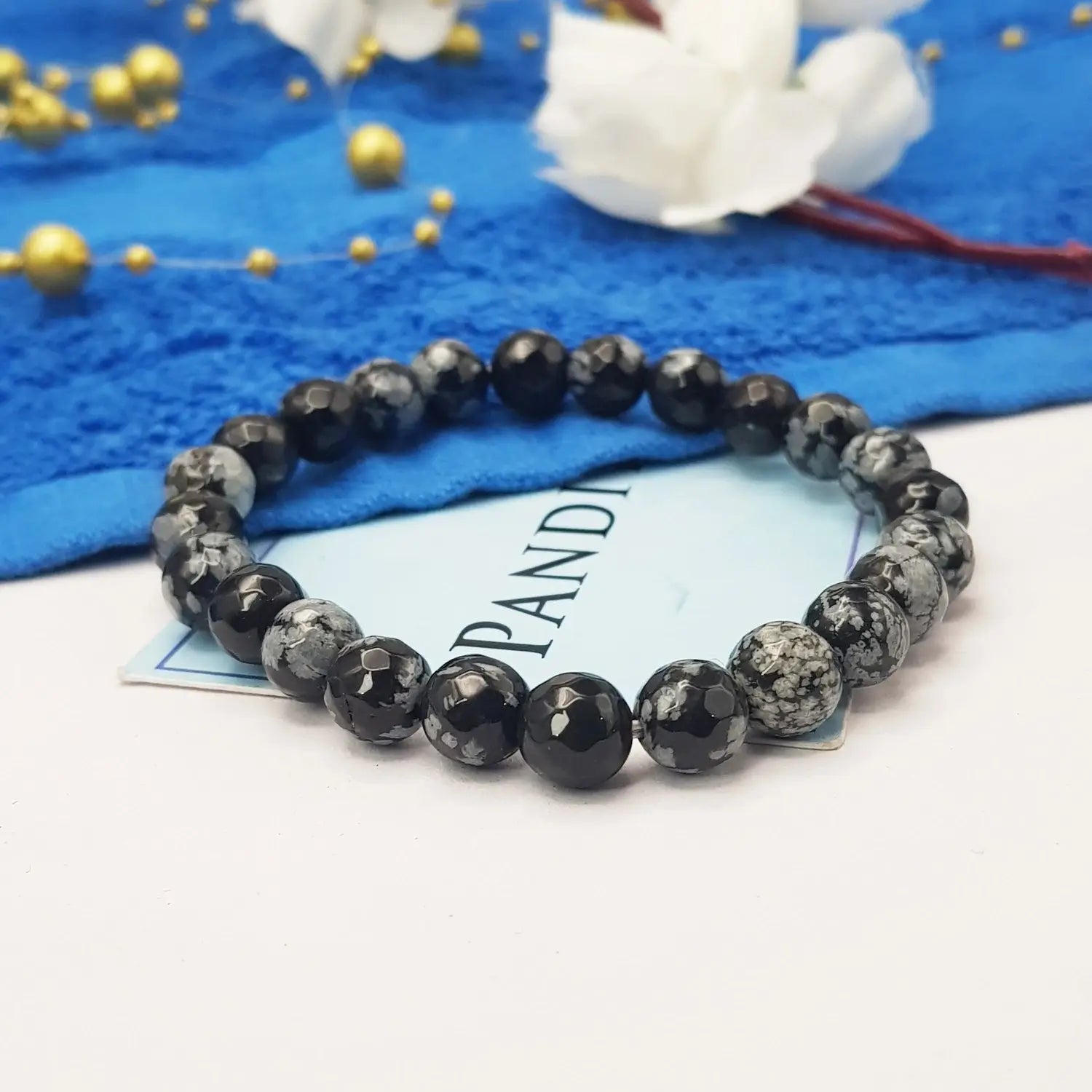 Snowflake Obsidian Diamond Cut Bracelet — front view of bracelet showing beads and stringing