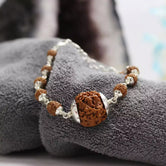 1 Mukhi Rudraksha Bracelet — close-up of 1 Mukhi Rudraksha stones revealing natural patterns